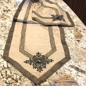 Table runner with embellishment. One small spot. 71” Tan with shimmer brown trim